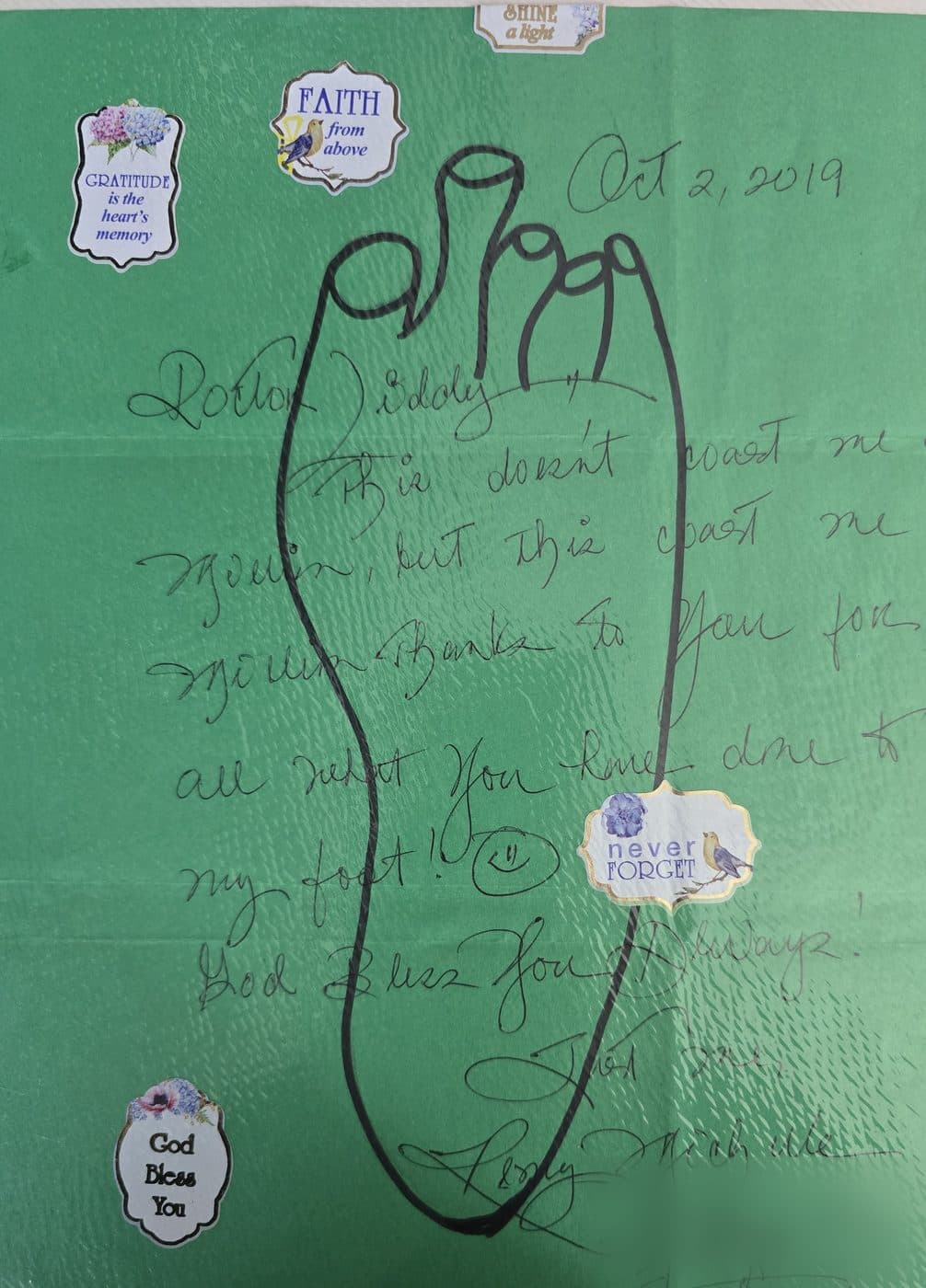A 2019 letter to Dr. Liddy on green paper, written inside a hand-drawn outline of a foot.