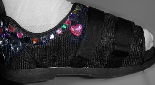 A post-surgical shoe a patient decorated with jeweled hearts in appreciation.