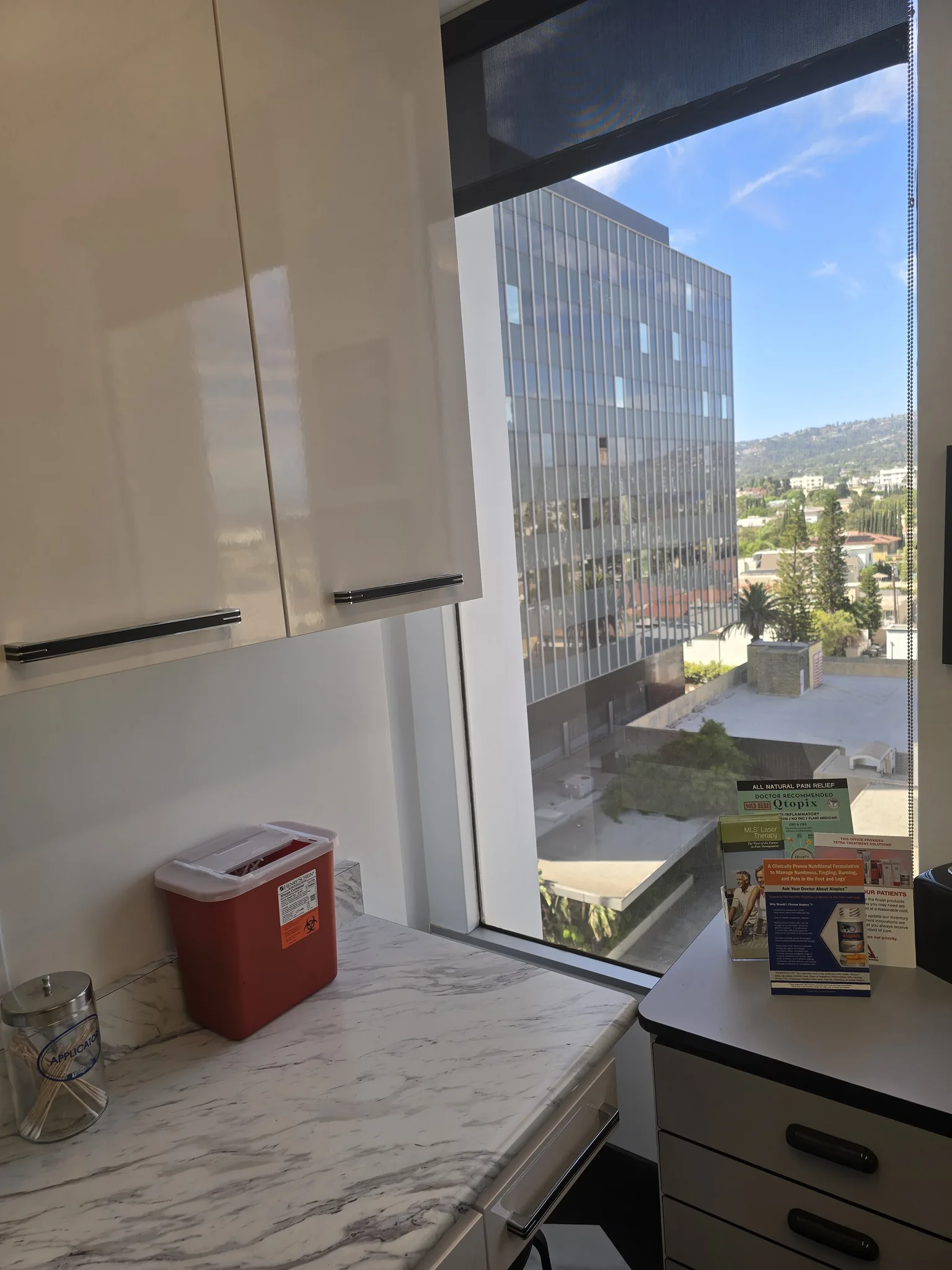 Treatment room with a marble counter and a window overlooking Beverly Hills